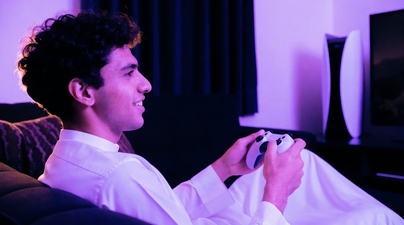 A player mid-game on a PS5 in a purple-lit gaming room